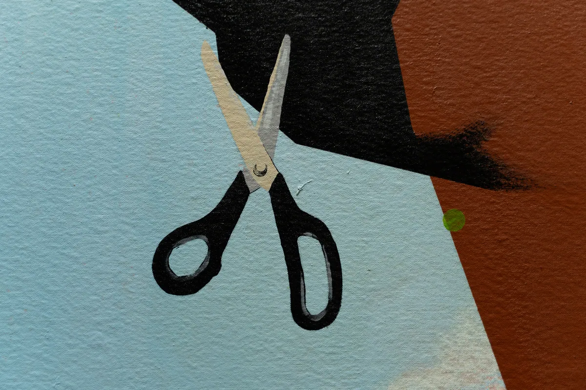Detail of the painted scissors floating against the blue ground