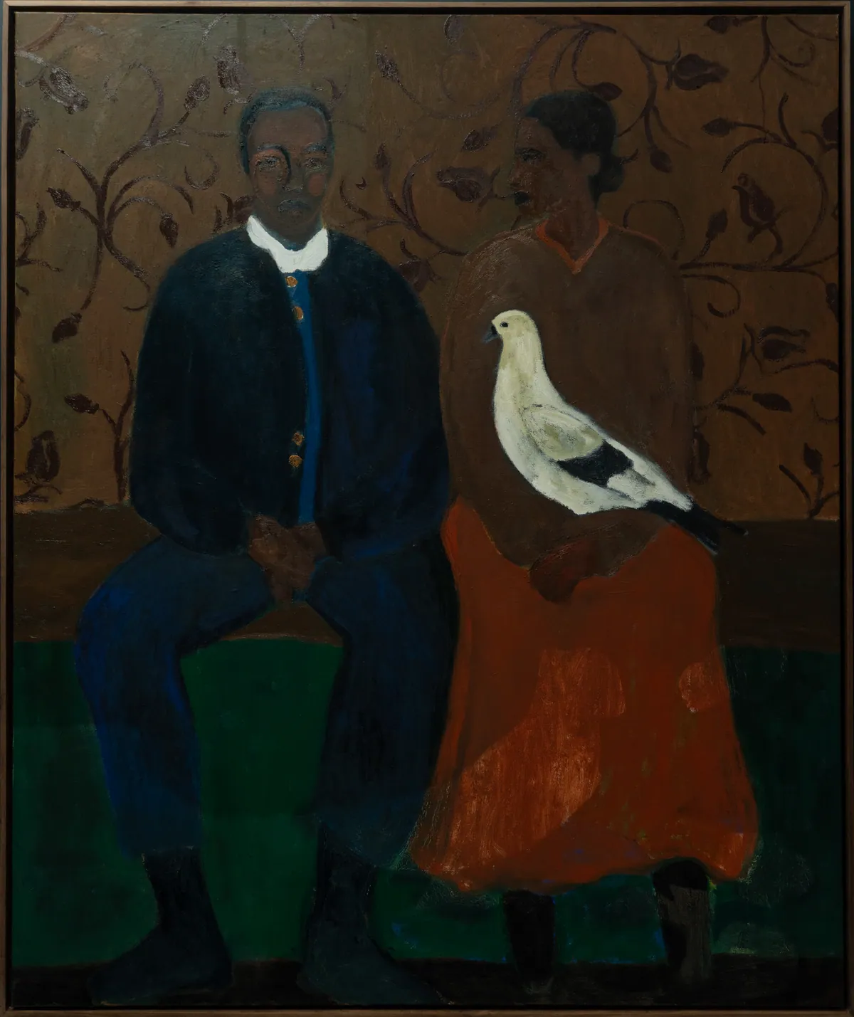 Full view: two seated figures in blue and orange with a white dove between them